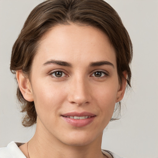 Joyful white young-adult female with medium  brown hair and grey eyes