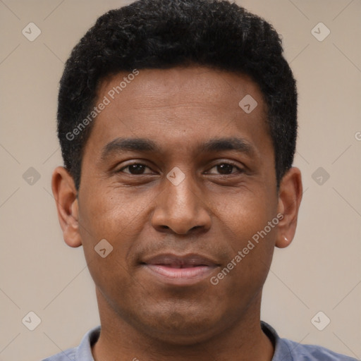 Joyful latino young-adult male with short  brown hair and brown eyes