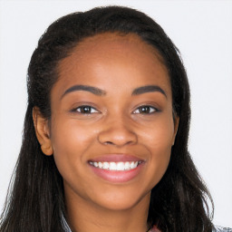 Joyful black young-adult female with long  brown hair and brown eyes