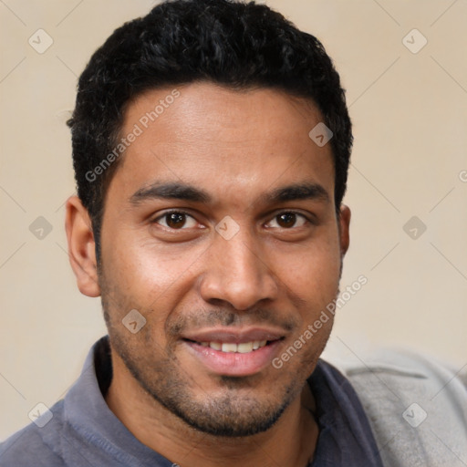 Joyful white young-adult male with short  black hair and brown eyes
