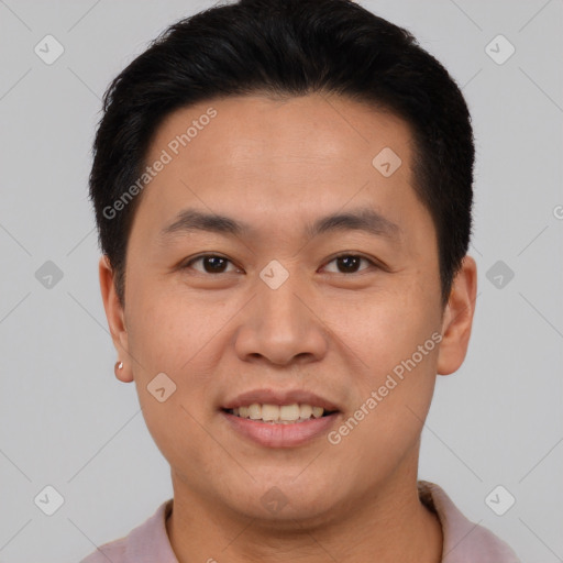 Joyful asian young-adult male with short  brown hair and brown eyes