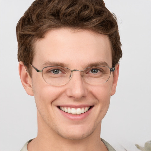 Joyful white adult male with short  brown hair and grey eyes