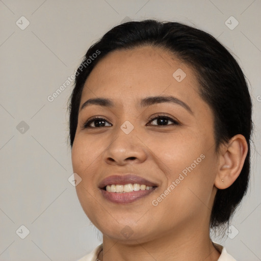 Joyful latino young-adult female with medium  black hair and brown eyes