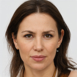 Joyful white adult female with long  brown hair and brown eyes