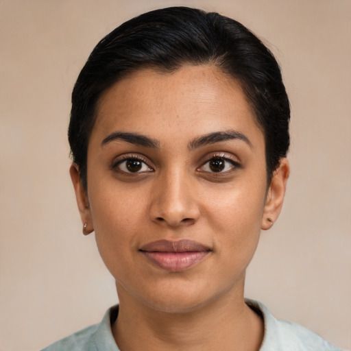 Joyful latino young-adult female with short  black hair and brown eyes