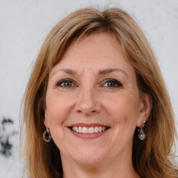 Joyful white adult female with long  brown hair and grey eyes