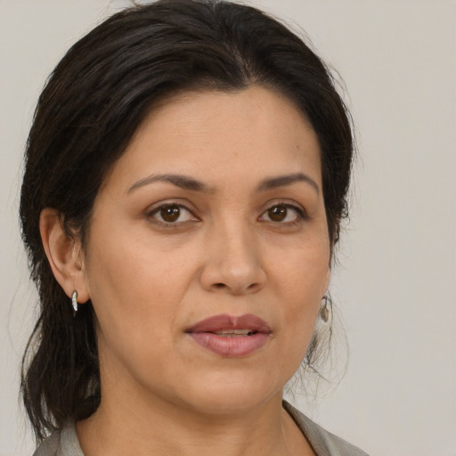 Joyful white adult female with medium  brown hair and brown eyes