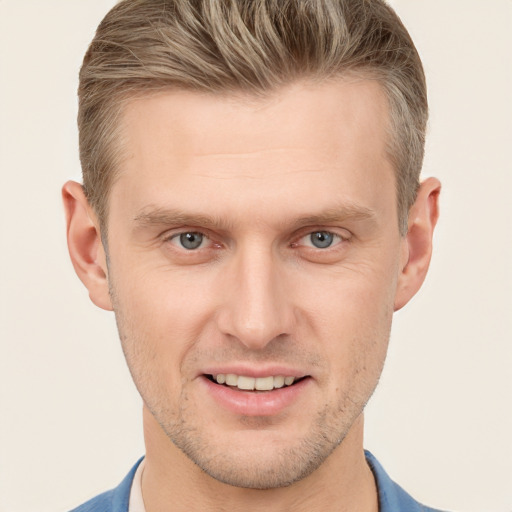 Joyful white young-adult male with short  brown hair and grey eyes