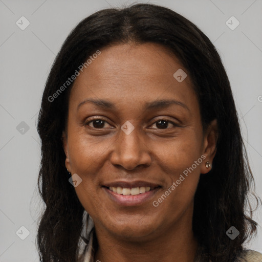 Joyful black adult female with long  brown hair and brown eyes