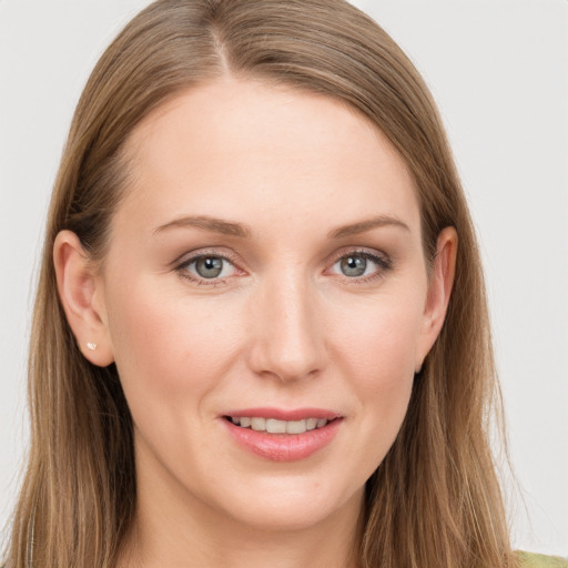 Joyful white young-adult female with long  brown hair and grey eyes