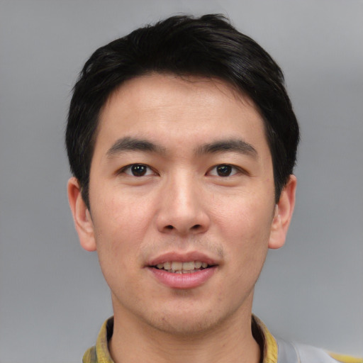 Joyful asian young-adult male with short  black hair and brown eyes