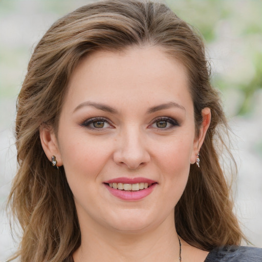 Joyful white young-adult female with medium  brown hair and blue eyes