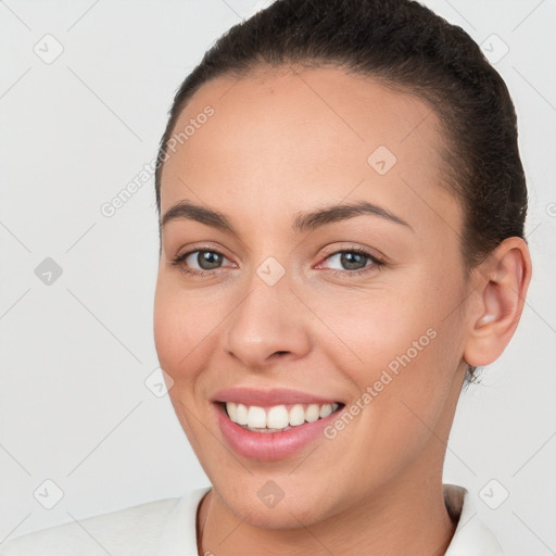 Joyful white young-adult female with short  brown hair and brown eyes