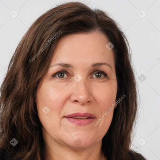 Joyful white adult female with long  brown hair and brown eyes