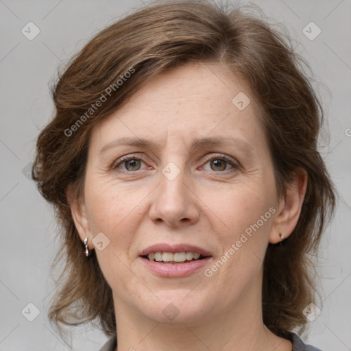 Joyful white adult female with medium  brown hair and grey eyes