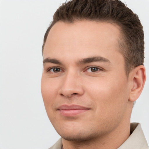 Joyful white young-adult male with short  brown hair and brown eyes