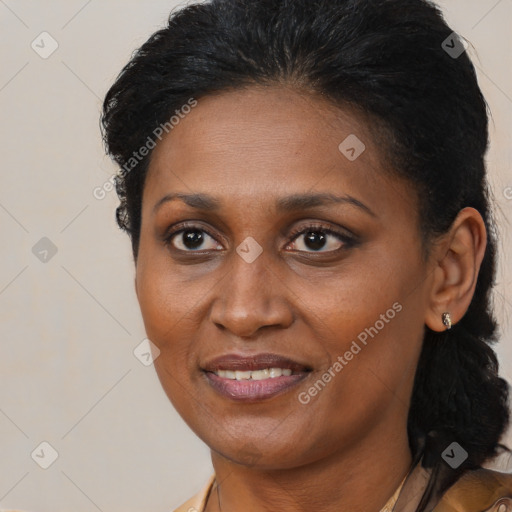 Joyful black adult female with short  brown hair and brown eyes