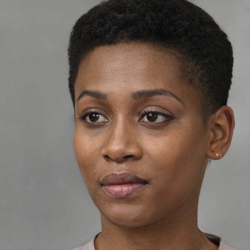 Joyful black young-adult female with short  black hair and brown eyes
