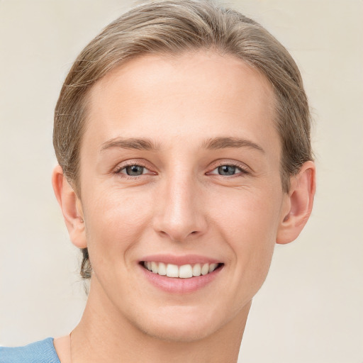 Joyful white young-adult female with short  brown hair and blue eyes