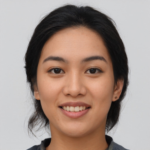 Joyful asian young-adult female with medium  black hair and brown eyes