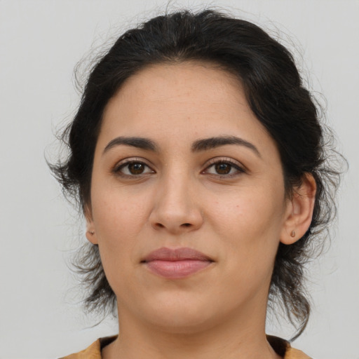 Joyful latino young-adult female with medium  brown hair and brown eyes