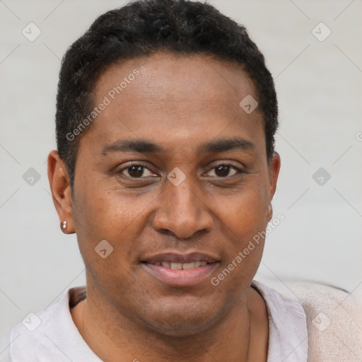 Joyful black young-adult male with short  brown hair and brown eyes