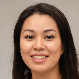 Joyful asian young-adult female with long  brown hair and brown eyes