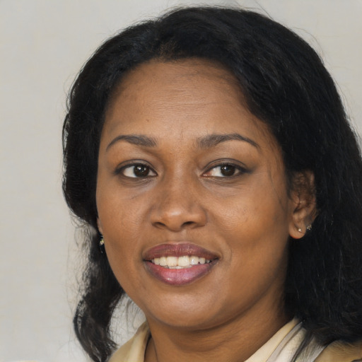 Joyful black adult female with medium  black hair and brown eyes