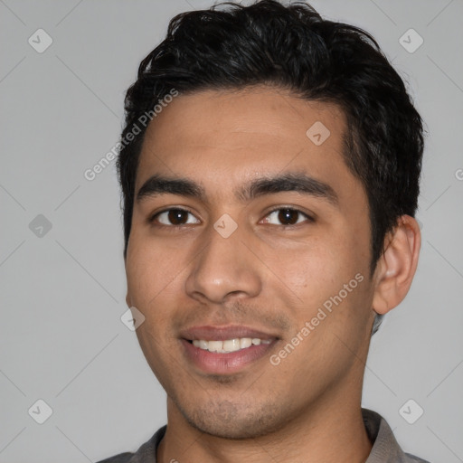 Joyful white young-adult male with short  black hair and brown eyes