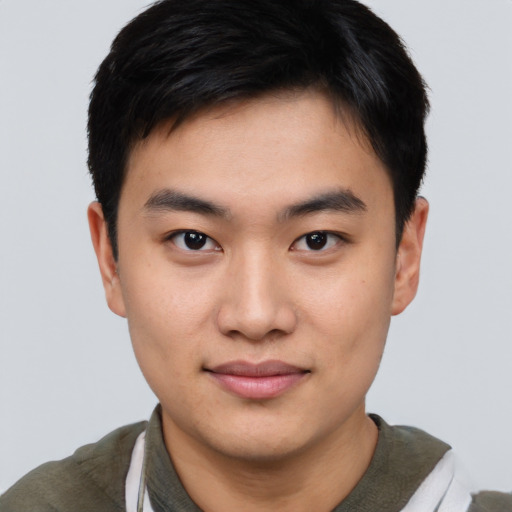 Joyful asian young-adult male with short  black hair and brown eyes