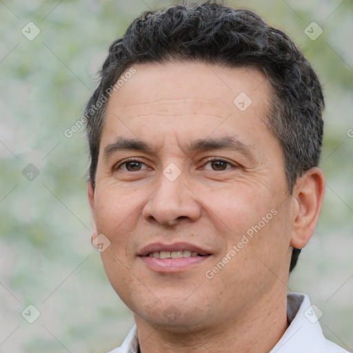 Joyful white adult male with short  black hair and brown eyes