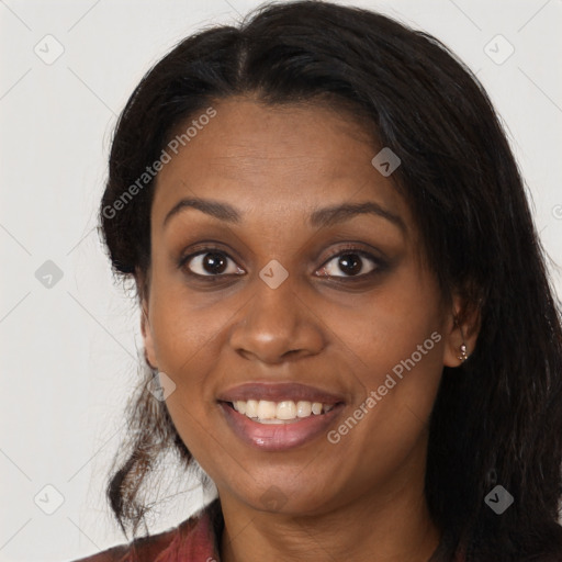 Joyful black young-adult female with long  brown hair and brown eyes