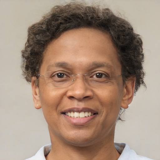 Joyful black adult male with short  brown hair and brown eyes