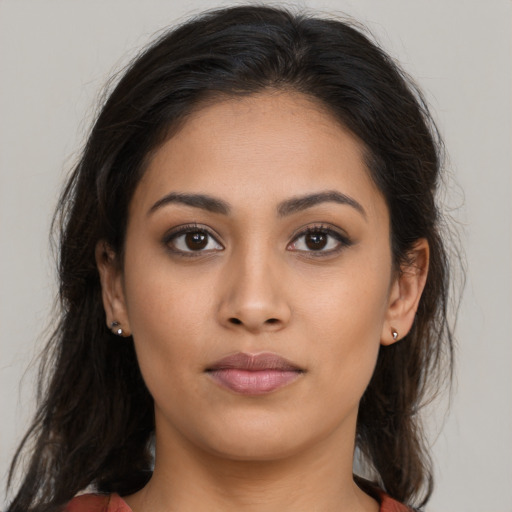 Neutral latino young-adult female with long  brown hair and brown eyes