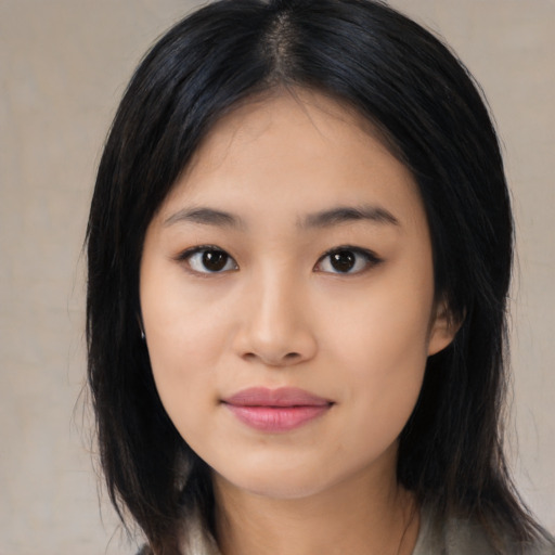 Joyful asian young-adult female with medium  black hair and brown eyes