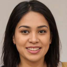 Joyful latino young-adult female with long  brown hair and brown eyes