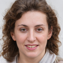 Joyful white young-adult female with medium  brown hair and green eyes