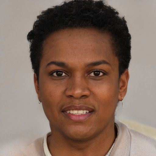 Joyful black young-adult female with short  black hair and brown eyes
