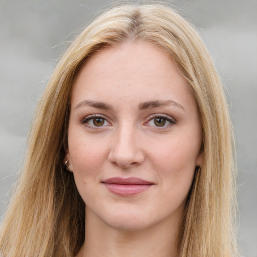 Joyful white young-adult female with long  brown hair and green eyes