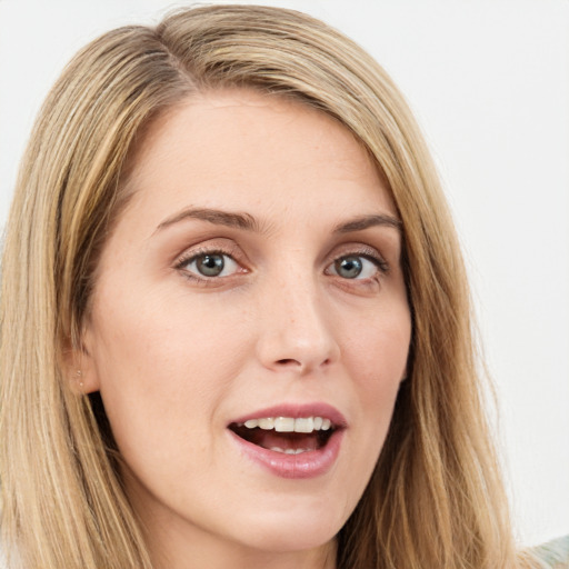 Joyful white young-adult female with long  brown hair and green eyes