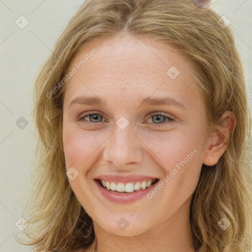 Joyful white young-adult female with long  brown hair and blue eyes