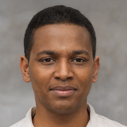 Joyful latino young-adult male with short  brown hair and brown eyes