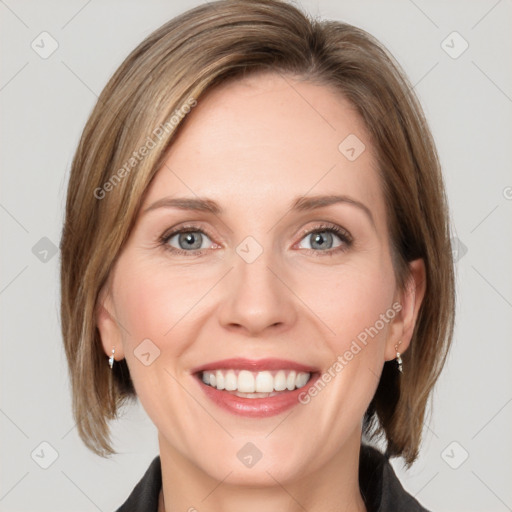 Joyful white adult female with medium  brown hair and blue eyes