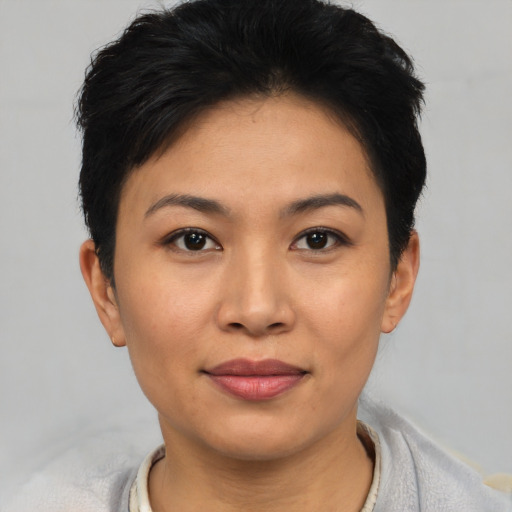 Joyful asian young-adult female with short  black hair and brown eyes