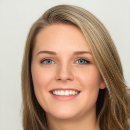 Joyful white young-adult female with long  brown hair and blue eyes