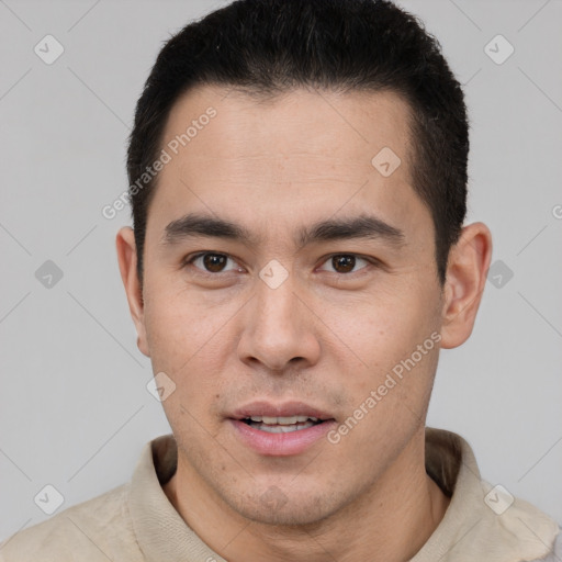 Joyful latino young-adult male with short  brown hair and brown eyes