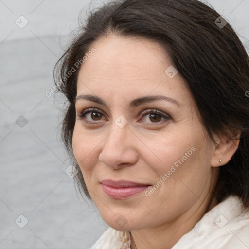 Joyful white adult female with medium  brown hair and brown eyes