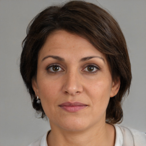 Joyful white adult female with medium  brown hair and brown eyes