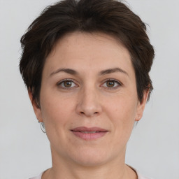 Joyful white adult female with short  brown hair and brown eyes