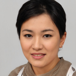 Joyful asian young-adult female with short  black hair and brown eyes